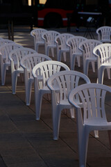 Empty plastic chairs in the city