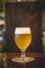Glass of beer on wooden table