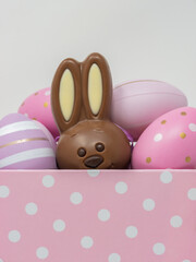 Chocolate Easter bunny hidden among Easter eggs