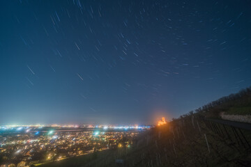 Star trails over a vineyard and the Rhine valley at Schriesheim in Germany.