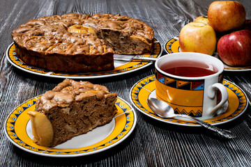 Sweet brown chocolate apple pie on the table made of natural wood