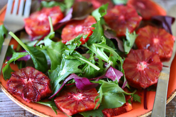 Healthy salad with arugula and citrus. Red orange salad. Fitness food. Vegan salad.