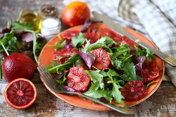 Healthy salad with arugula and citrus. Red orange salad. Fitness food. Vegan salad.