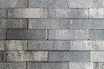 Obraz premium Wall is made of gray facing bricks. Color - Spun Pearl. Light and dark blotches.