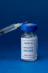 Vial of conoravirus Covid-19 vaccine with a syringe isolated.