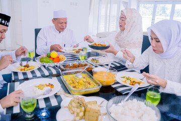 Muslim family having dinner during Eid Mubarak