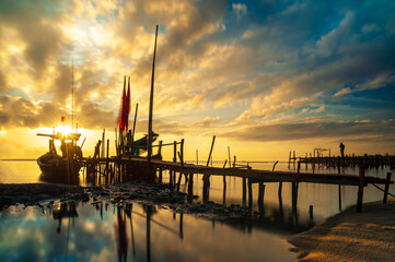 Asian traditional fishing port and the sun is rising
