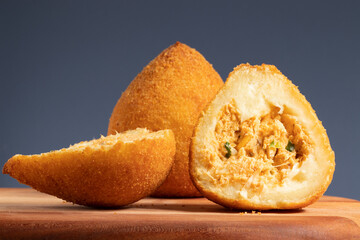 Brazilian snack, selective focus on two halves of coxinha of chicken.