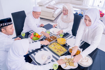 Three generation Muslim family having dinner