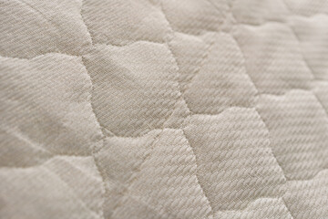 Background of the upholstery of the mattress closeup.