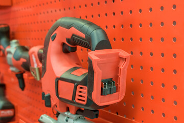 Power tools on display stand. Colors - red, black. Power tool shop concept. Selective focus.
