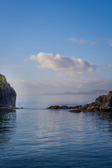 Rocks protruding from the surrounding blue ocean waters.