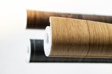 Linoleum. Three rolls of linoleum on a white background.