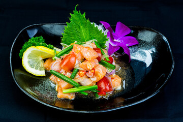 Fresh salmon salad with tomato, fresh chili, onion, and orchids, Lemon