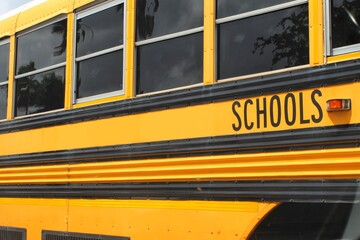 Yellow school bus from a county public school system parked in a parking lot