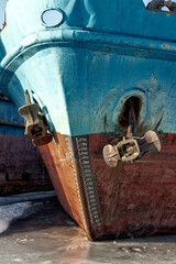 Cargo ships are in a shipyard frozen into the ice.