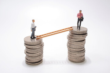 mini people walking from low to high pile of coins.