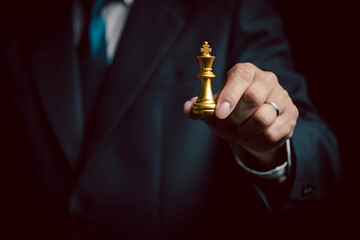 Business man hold king chess piece, business strategy concept