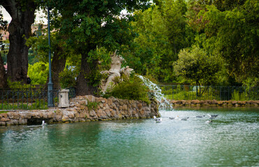 antique park rome with columns and monuments a lot of greenery and sculptures marble