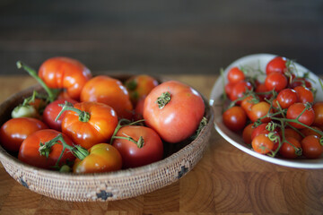 fresh tomatoes in basket on wooden table