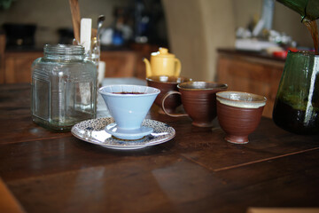 barista preparing brewing coffee with coffee maker and drip kettle.