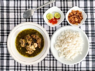 Nasu Cemba is a traditional food from Enrekang, South Sulawesi, Indonesia. Made from beef ribs and some condiments, served with rice, fried onion, chilli and kaffir lime.