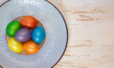 Colorful bright Easter holiday eggs on a plate