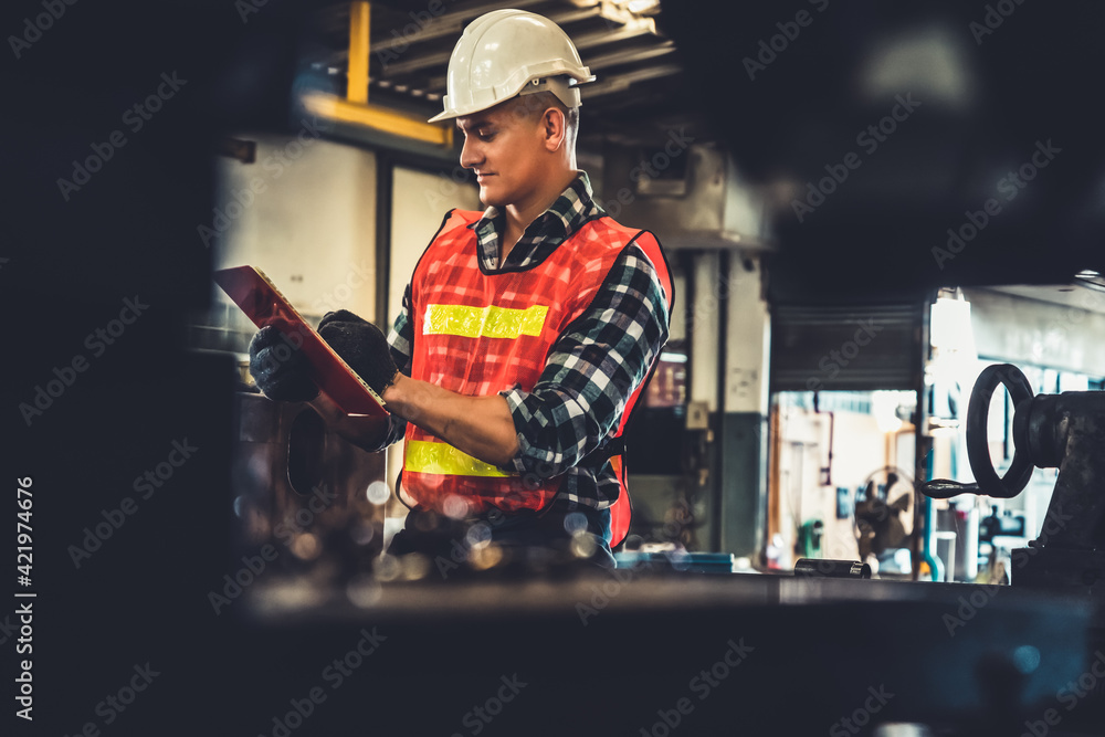Poster manufacturing worker working with clipboard to do job procedure checklist . factory production line 