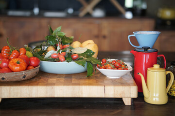 tomatoes, lemon, Indian ivy-rue and tea pot in kitchen