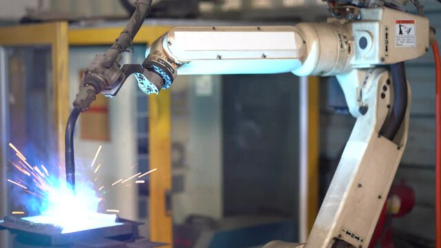 automatic welding robot arms machine in factory industry. robotics technology