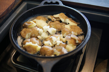 fried potatoes roasting in frying pan