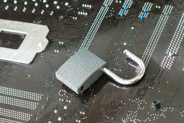 the open lock lies on the computer's motherboard the concept of information protection data hacking