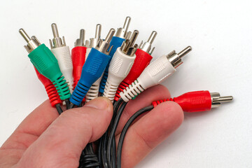 multi-colored connectors of electrical wires in a person's hand