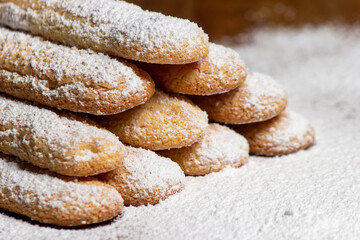 Homemade ladyfingers with icing sugar.