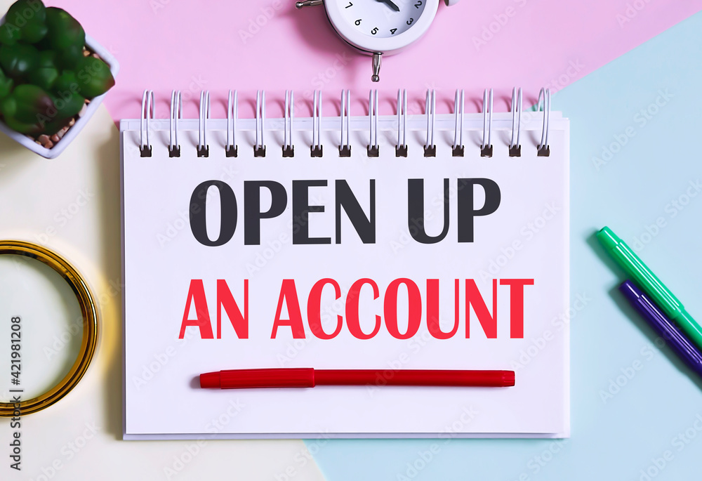 Poster open up an account text written on a notebook with pencils, magnifier