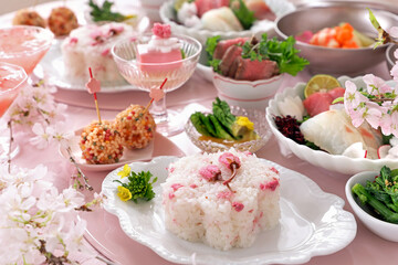 Obraz na płótnie Canvas Home made spring lunch plate with cherry blossom rice, roast beef, sashimi, spring vegetables, cherry blossom tofu for cherry blossom viewing. お花見ランチ　お花見御膳　さくら御膳　桜御膳　おうちでお花見