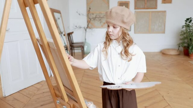 A talented pioneer artist paints an oil painting on canvas Contemporary art of a young artist