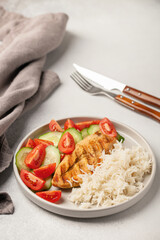 Chicken breast grill with rice and vegetables on a plate on the table. Diet nutrition