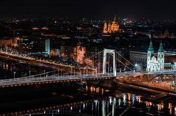 Fototapeta na wymiar Night Budapest, cityscape, reflection of night lights on the water, Erzsebet bridge on the Danube river.