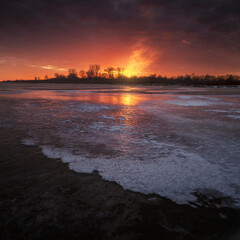 beautiful sunset reflected on the ice of the river