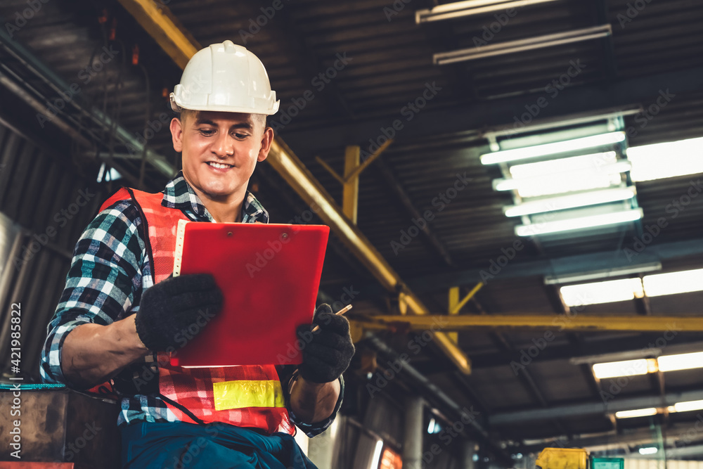 Poster manufacturing worker working with clipboard to do job procedure checklist . factory production line 