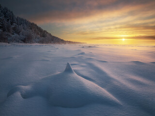 blocks of ice on the river at sunset