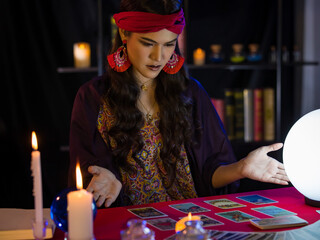 Asian witch with tarot cards