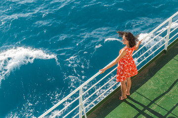 a woman is sailing on a cruise ship and looks at the water
