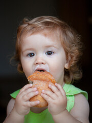 Baby with bread. Cute toddler child eating sandwich, self feeding concept.