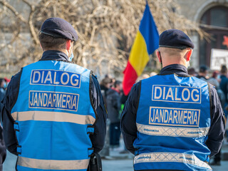 Police officers and Gendarmerie or military police closely supervising the demonstrators from...