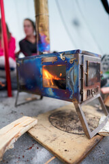 Life in a lavvo tent or tipi in the cold winter. Focus on the hot firestove that heats up the tent....
