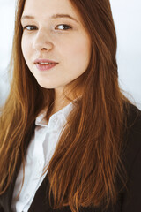 Business woman standing in white office. Student girl and success concept