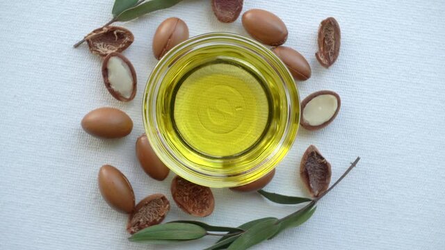Argan oil and seeds on a white background. Argan oil based cosmetics concept