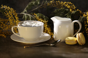 still life with coffee, macaroons and yellow flowers